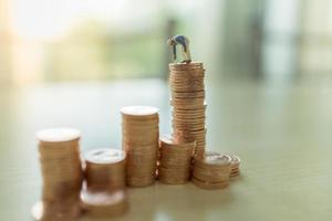 Business, Money, Planning and Saving Concept. Close up of worker using brush to painting coin on top stack of coins with copy space. photo