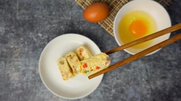 Selective focused Omelet, egg roll with vegetables and ham. photo