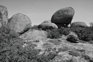 some big rocks in black and white photo