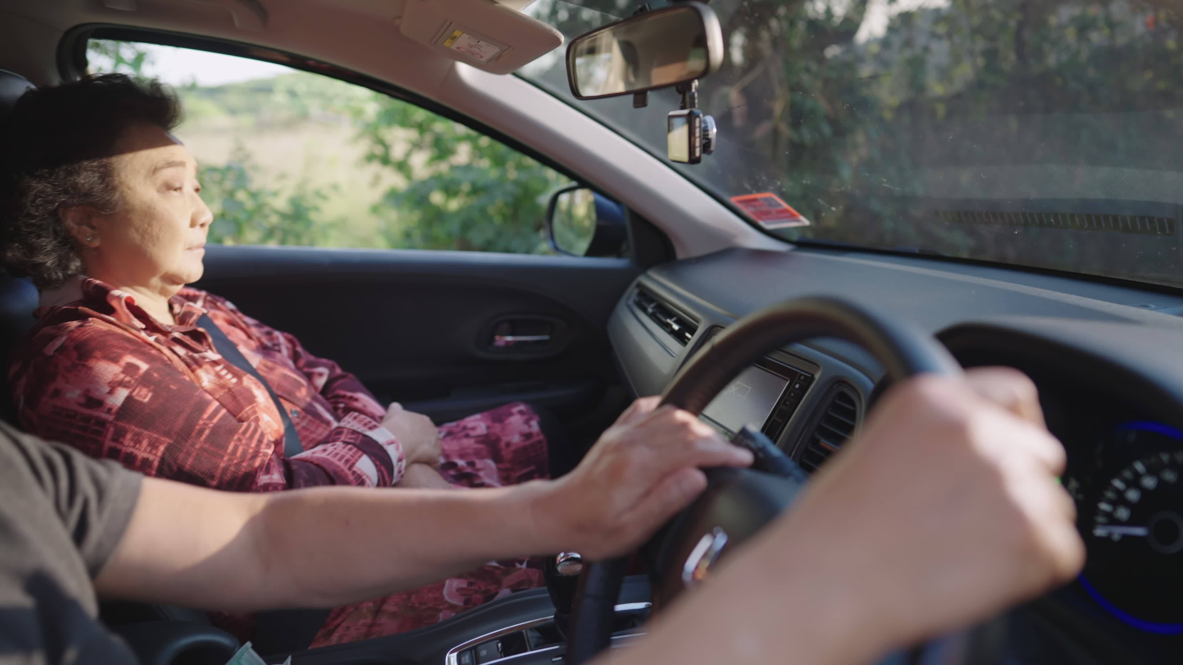 Upset husband and wife sitting silent after quarrel in car, a thoughtful meddle aged wife sitting and looking on front road out of car quietly while husband is driving non stop, marital conflict