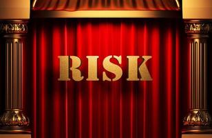 risk golden word on red curtain photo