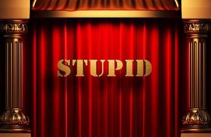 stupid golden word on red curtain photo