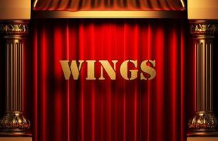 wings golden word on red curtain photo