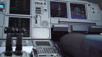 Close-up an electronic flight control panel with relaxing copilot leg in his station seat, pilot in the aircraft with dashboard, a commercial airlines industry, pre-flight and safety check preparation video