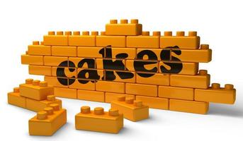 cakes word on yellow brick wall photo