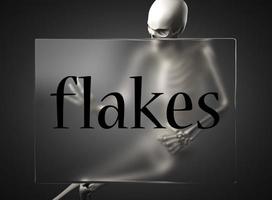 flakes word on glass and skeleton photo