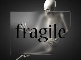 fragile word on glass and skeleton photo