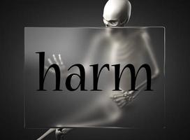 harm word on glass and skeleton photo