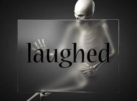 laughed word on glass and skeleton photo