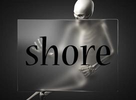 shore word on glass and skeleton photo