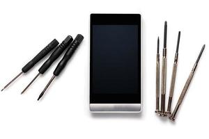 Smartphone and  screwdrivers photo