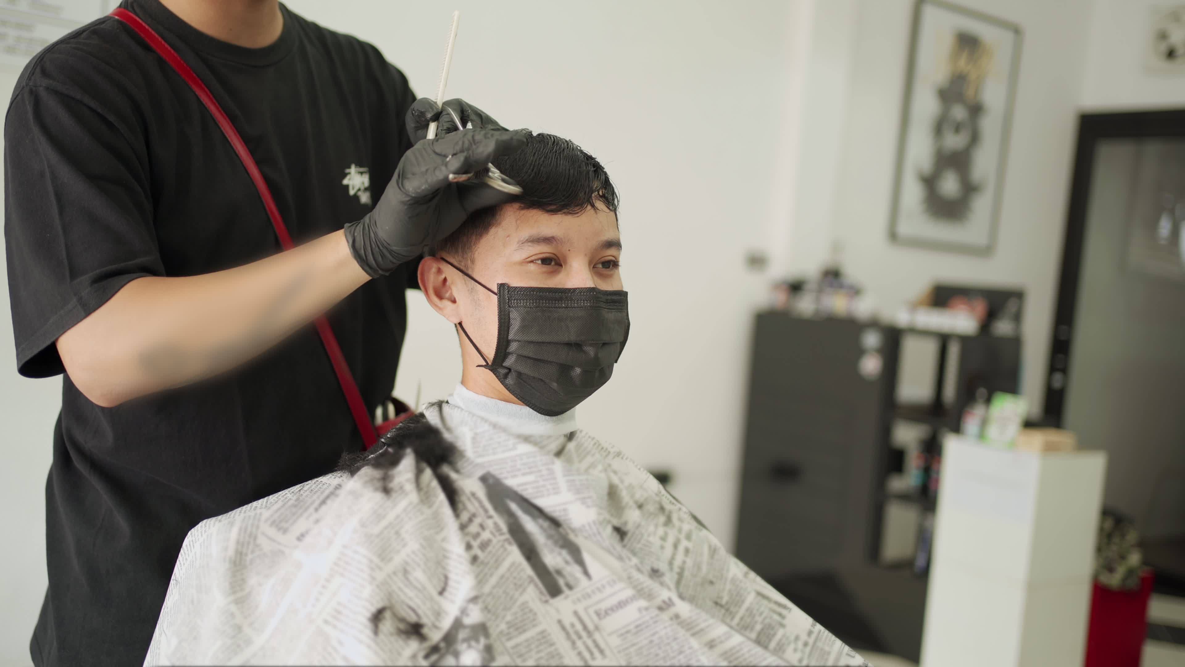Asian Man Getting Hair Cut at the Barbershop wearing black mask to protect  from infectious disease, Professional Barber. man health care industrial  Corona virus Pandemic Covid-19 re-open business 7387815 Stock Video at