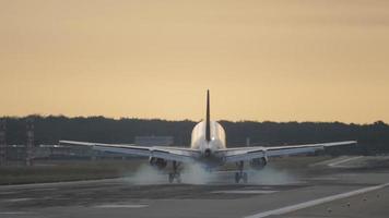 Airplane landing at golden sunset video