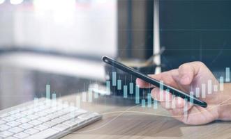 Hand using tablet and laptop analyzing sales data and economic growth graph chart. Business strategy. Digital marketing. Business innovation technology concept photo