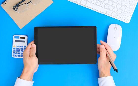 Blank tablet screen while typing on a keyboard, as well as a screen mockup for further customization, can be used for a variety of purposes. area for copying photo