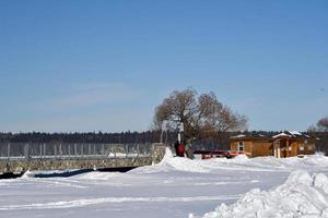 a footbridge over a frozen lake photo