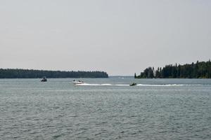 a motor boat pulling a rubber raft