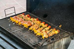 Barbecue with delicious grilled meat on grill photo