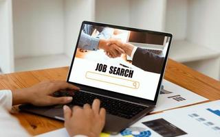 woman using laptop for job search concept, find your career, woman looking at online website photo