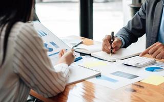 reunión del equipo de negocios a la conferencia, colaboración discutiendo el análisis de trabajo con datos financieros y proyecto de estrategia comercial de marketing, presentación y lluvia de ideas para obtener ganancias de la empresa foto