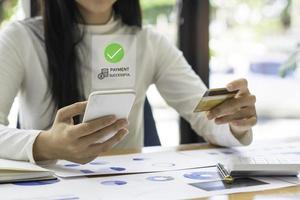 Woman using mobile smart phone, online payment, banking and online shopping at home. Business and technology. photo