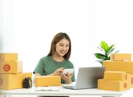 Starting small businesses SME owners female entrepreneurs check online orders to prepare to pack the boxes, sell to customers, sme business ideas online. photo