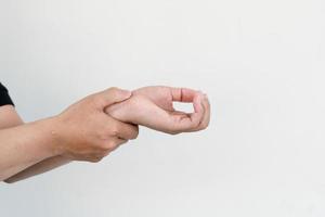 unhappy young man suffering from pain in hand at home,healthcare and problem photo