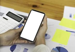 Top view Mockup image hand using a smartphone man Holding Cell Phone With Blank Screen photo