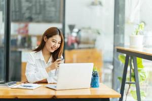 Online Meeting. Happy young woman using laptop computer for virtual conferencing, having video call at home. Cheerful Asian female communicating with colleagues, friends remotely. photo