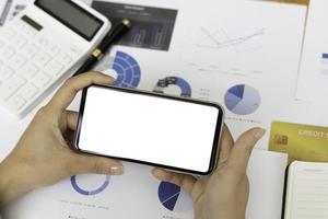 Top view Mockup image hand using a smartphone man Holding Cell Phone With Blank Screen photo