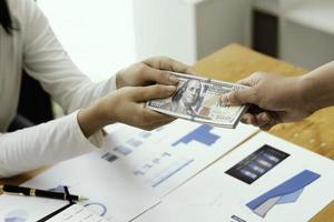 Businessman giving or paying money, US dollar bills photo