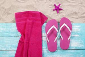 Sand copy space. Sand background top view.Beach towel, beach slippers and starfish photo
