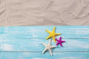 Sand copy space. Sand background top view. starfish on wooden background photo
