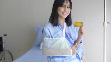 A young patient woman is holding credit card , admitting in hospital , Health care  concept photo