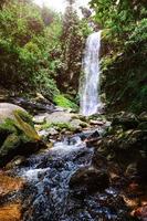 A large waterfall in the humid tropical forest of Thailand photo