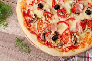 Pizza with ham, mushrooms and olives photo