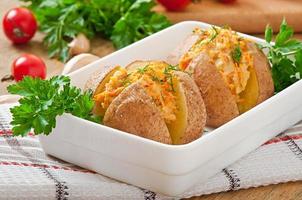Baked potatoes stuffed with minced chicken and carrots photo