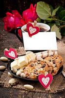 Cup of coffee with white chocolate, almonds and cookies photo