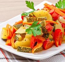 Roasted vegetables - zucchini, tomatoes, carrots, onions and paprika photo