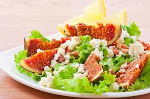 Green salad with figs, cheese and walnuts photo