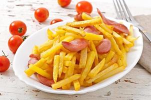 Fried potatoes with sausage on a plate photo