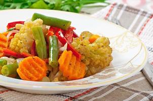 Steamed vegetables - cauliflower, green beans, carrots and onions photo