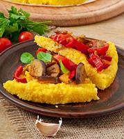 Polenta with vegetables - corn grits pizza with tomato and eggplant photo