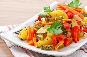 Roasted vegetables - zucchini, tomatoes, carrots, onions and paprika photo