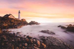 Sunset on the coast with lighthouse photo
