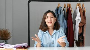 Young woman  influencer beauty fashion blogger presentation drass and dressing gown, jacket, jeans. video