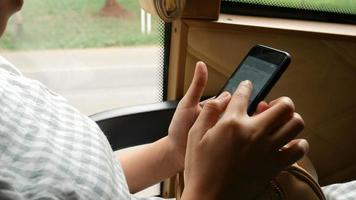 Woman using smartphone on bus transportation. video