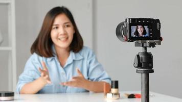 Young woman beauty fashion blogger recording video Presen her product.