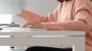 Young girl working with computer laptop at home office. video