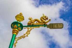 Artistic turquoise green street lantern with golden dragon Phuket Thailand. photo